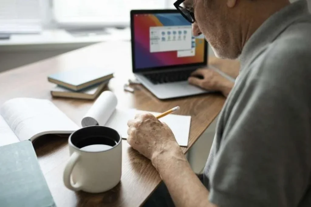 1_senior_man_doing_online_classes_laptop_home-34913274